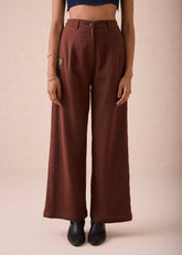 A Model Wearing Brown Organic Cotton Under The Sun Organic Cotton Trousers, curated by Only Ethikal